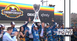 Crowned: Kyle Larson hoists the Bill France Cup