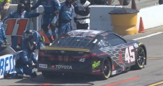 Tyler Reddick pits in the No. 11 stall for a loose wheel