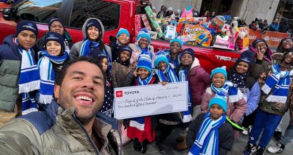 Bubba Wallace poses for a photo with the Boys & Girls Club.