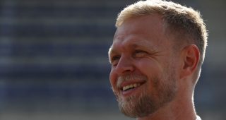Kevin Magnussen looks on at a race.