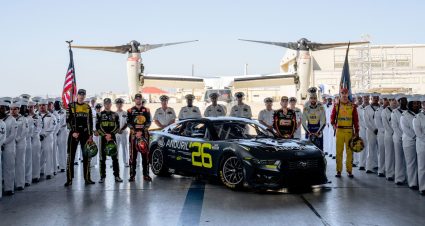 NASCAR Cup Series cars race to the start-finish line on May 11, 2025 at Kansas Speedway.