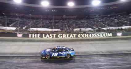 Ryan Blaney drives his No. 12 Team Penske Ford past The Last Great Colosseum sign on the wall at Bristol Motor Speedway.