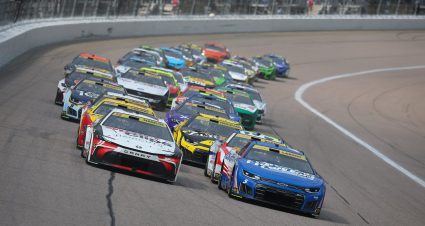 Kyle Larson, driver of the No. 5 HendrickCars.com Chevrolet, and Denny Hamlin, driver of the No. 11 Sport Clips Haircuts Toyota, lead the field during the NASCAR Cup Series Hollywood Casino 400 at Kansas Speedway on Sept. 27, 2026 in Kansas City, Kansas.