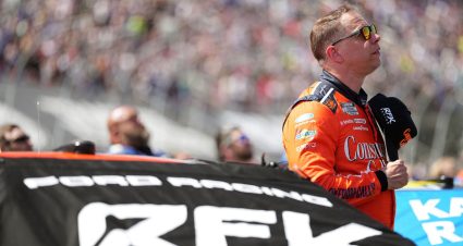 Brad Keselowski looks on next to his RFK Racing Ford in the NASCAR Cup Series.